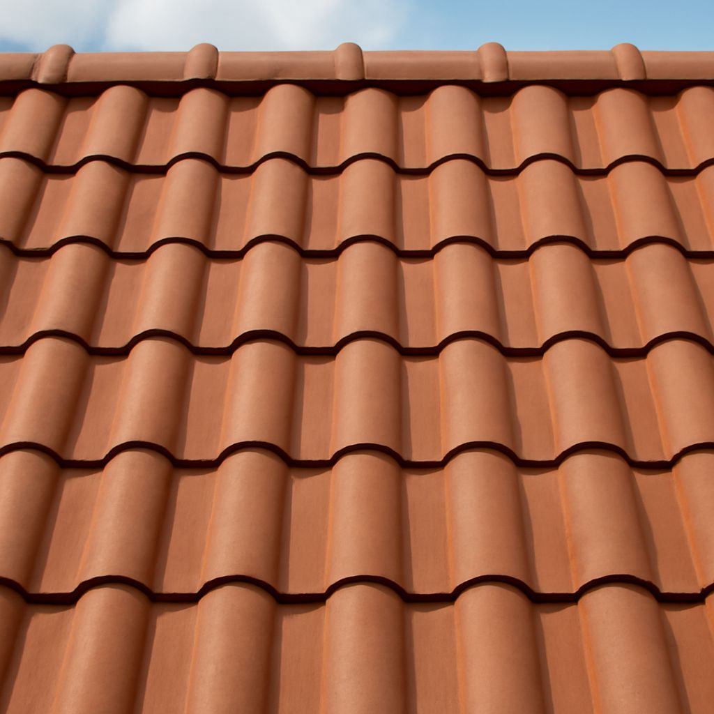 A roof featuring clay tile roofing and terracotta roof shingles